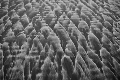 Abstract patterns on famous black sand of New Zealand beaches. Fotos de archivo