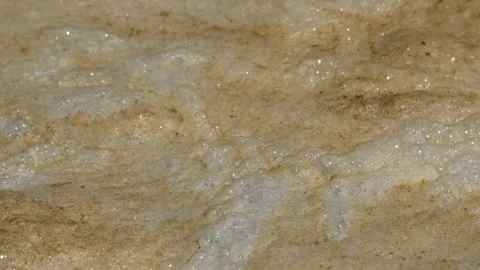 Abstract patterns, shapes and textures of white and brown river waste foam 1 Video stock 287996593
