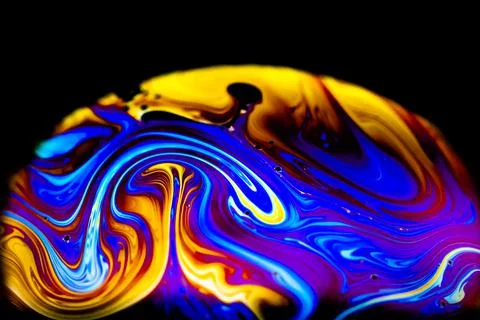 Abstract patterns with various vibrant colors on the soap bubble. Stock Photos