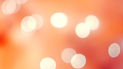 Abstract peach bokeh lights on defocused deep orange background Vídeos de archivo 100229640
