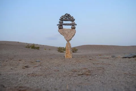 An abstract photograph of a rock stack with a tree on top Stock Photos