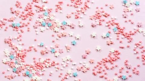 Abstract pink background with many small candies. Stock Photos