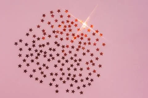Abstract pink background with sparkles in the shape of stars. Stock Photos