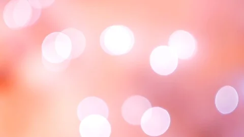 Abstract pink bokeh lights on smooth defocused bright peach background Vídeos de archivo 100229589