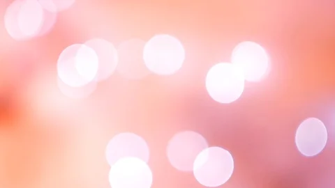 Abstract pink bokeh lights on smooth defocused bright peach background Vídeo Stock 100229593