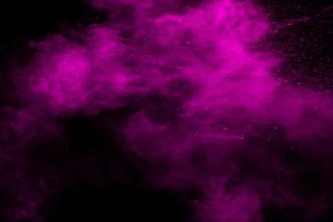 Abstract pink dust particles explosion on black background.Freeze motion of.. Illustrazione stock