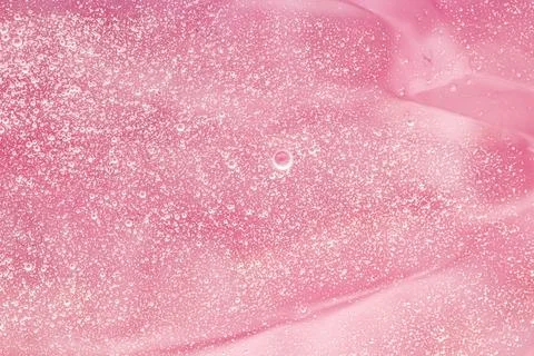 Abstract pink liquid background, paint splash, swirl pattern and water drops Foto stock