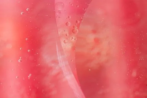Abstract pink liquid with bubbles and swirling patterns.  Perfect for backg.. Stock Photos
