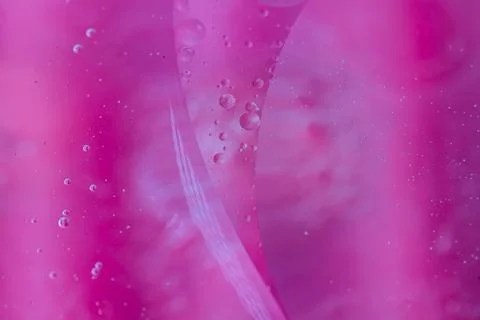 Abstract pink liquid with bubbles and streaks.  A vibrant, textured backgro.. Stock Photos