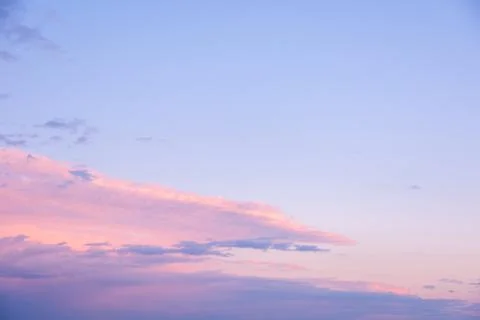 Abstract pink sunset sky background with motion blur. Bright pink-blue sky ba Stock Photos
