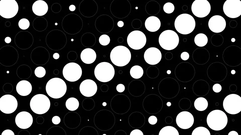Abstract polka dot pattern featuring various sizes of white circles on black Video stock 288186112