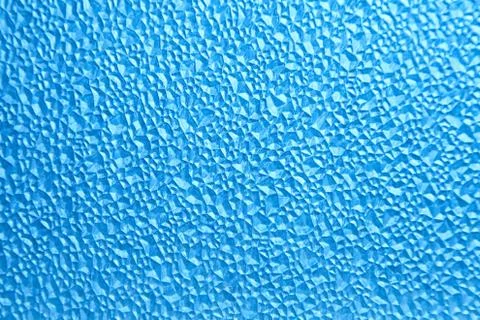 Abstract polygonal pattern on a blue plastic window on the lumen Stock Photos