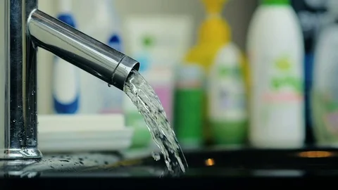 Abstract powerful stream of water flowing from an aluminum tap in the bathroom. Stock Footage 81870314