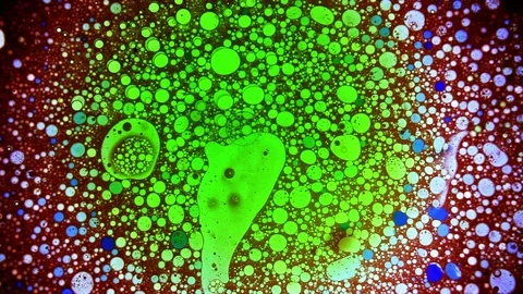 Abstract psychedelic dye dinamic pattern with green and blue balls Stock Footage 124284014