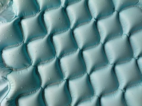 Abstract Quilted Pattern of a Cyan Camping Sleeping Pad or Pool Float Stock Photos