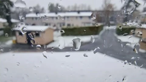 Abstract rain and snow, water droplets on window Stock Footage 239418688