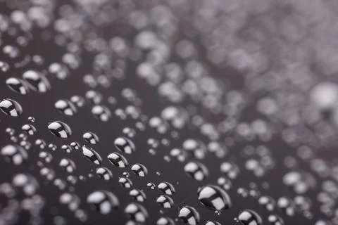 Abstract rain drops on a black background closeup Stock Photos