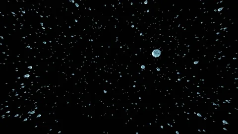 Abstract rain in zero gravity. Many round drops of water, similar to small Stock Footage 129944390