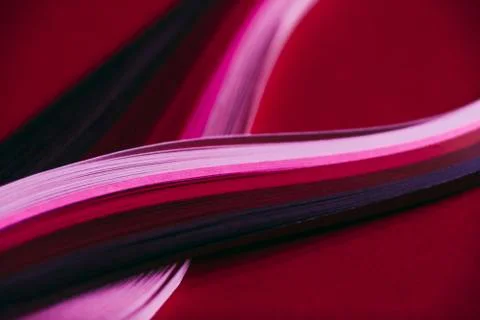 Abstract rainbow paper wave pattern on red background Stock Photos