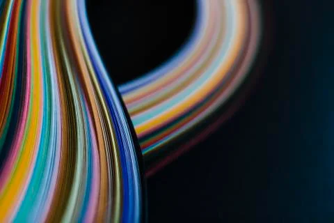 Abstract rainbow paper wave pattern on black background Stock Photos
