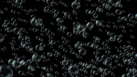 Abstract rainbow soap bubbles slowly descend from top to bottom on a black Stock Footage 164633730