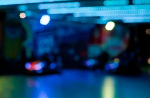 Abstract random colourful defocused blurred go-kart cars of fun fair backgrou Stock Photos