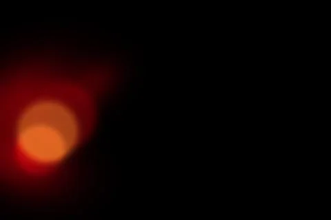 Abstract red and orange light bokeh effect on a dark black background, crea.. Stock Illustration