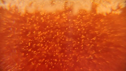 Abstract red background. Bubbles in a glass of beer. Irish Red Ale background Stock Footage 105507096