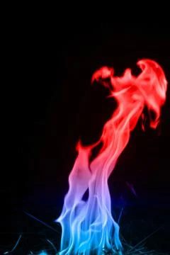 Abstract red-blue fire flames on dark background. Stock Photos