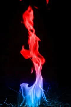 Abstract red-blue fire flames on dark background. Stock Photos