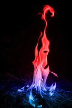 Abstract red-blue fire flames on dark background. Stock Photos