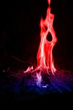 Abstract red-blue fire flames on dark background. Stock Photos