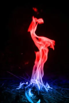 Abstract red-blue fire flames on dark background. Stock Photos