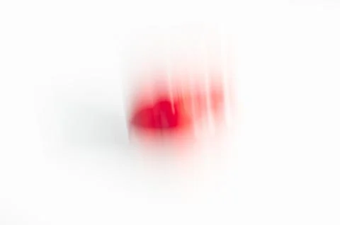 Abstract red blur on white background. Motion blurred object with high key 스톡 사진