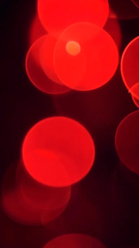 Abstract red bokeh lights floating softly on a dark background. Vertical video. Stock Footage 310228913