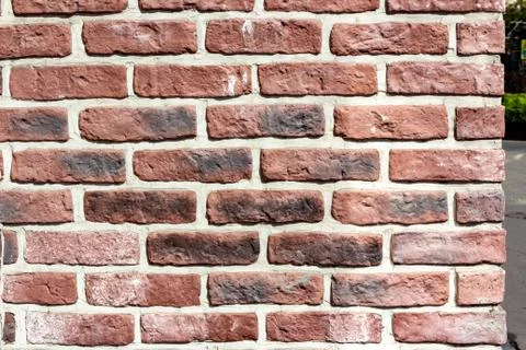 Abstract red brick wall texture with black spots for the background for the Stock Photos