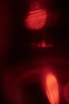 Abstract red light leak texture background against a dark backdrop. Illustrazione stock