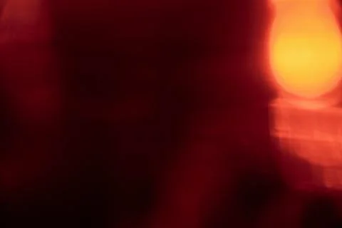 Abstract red light leak texture background against a dark backdrop. Stock Photos