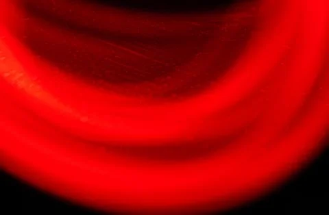 Abstract red light motion blur with curved lines on dark background, glowing 스톡 사진