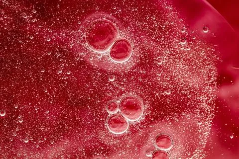 Abstract red liquid background, paint splash, swirl pattern and water drops Foto stock