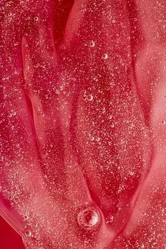 Abstract red liquid background, paint splash, swirl pattern and water drops Foto stock