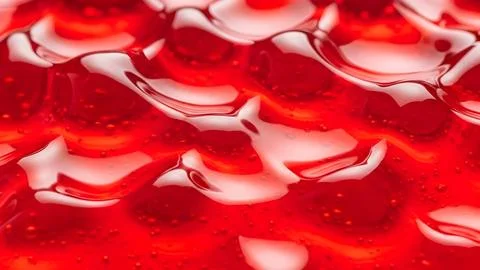Abstract red liquid surface with shiny light reflections and smooth flowing.. Foto stock