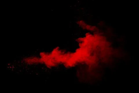 Abstract red powder on black background. Red color clouds. Stock Photos