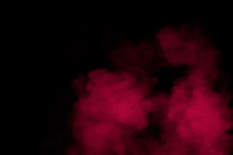Abstract red powder dust explosion on black background. Stock Photos