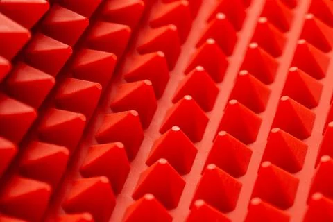 Abstract red silicone pyramids mat close-up background 库存照片