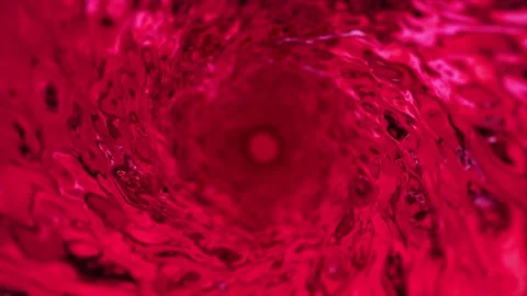 Abstract red water background. Slow motion shot of rotating water. Wine or ju Stock Footage 142534233