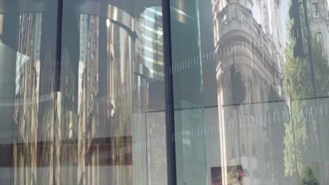 Abstract reflection of city in the glass. A bus passing by reflecting on Stock Footage 104628407