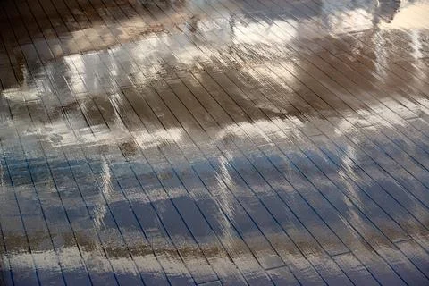 Abstract reflection of cruise ship structure on wet deck Фото