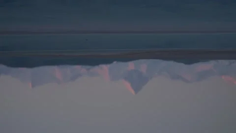 Abstract reflection of Khan Tengri mountains in Lake Tuzkol at sunrise Stock Footage 333911491