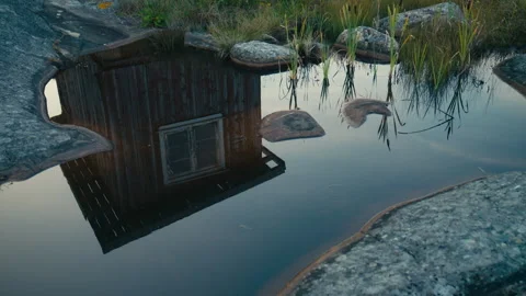 Abstract Reflection of Rustic Boathouse in a Coastal Tidal Pool Stock Footage 341071252